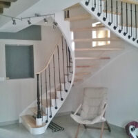 Escalier une crémaillère de jour en bois avec crémaillères teintées blanc et marches vernis mat